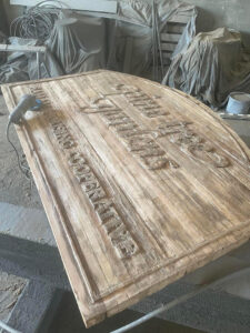 Kavips Coop Gardens sign sandblasted before painting